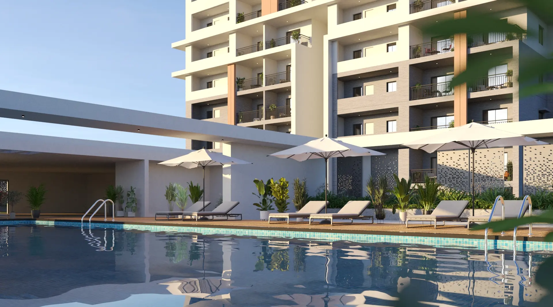 The swimming pool, loungers and shades beside a tower at Bricks Marvella